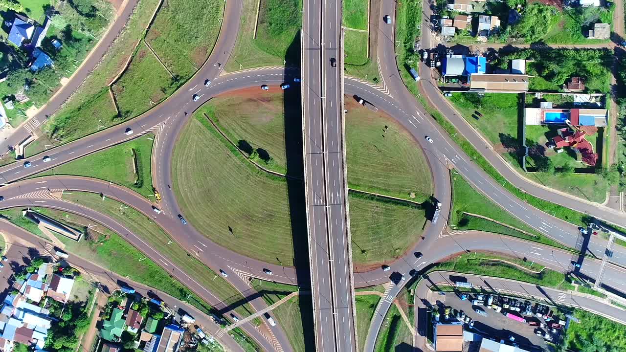 A drone's aerial perspective captures a large intersection bustling with traffic and vehicles moving in different directions