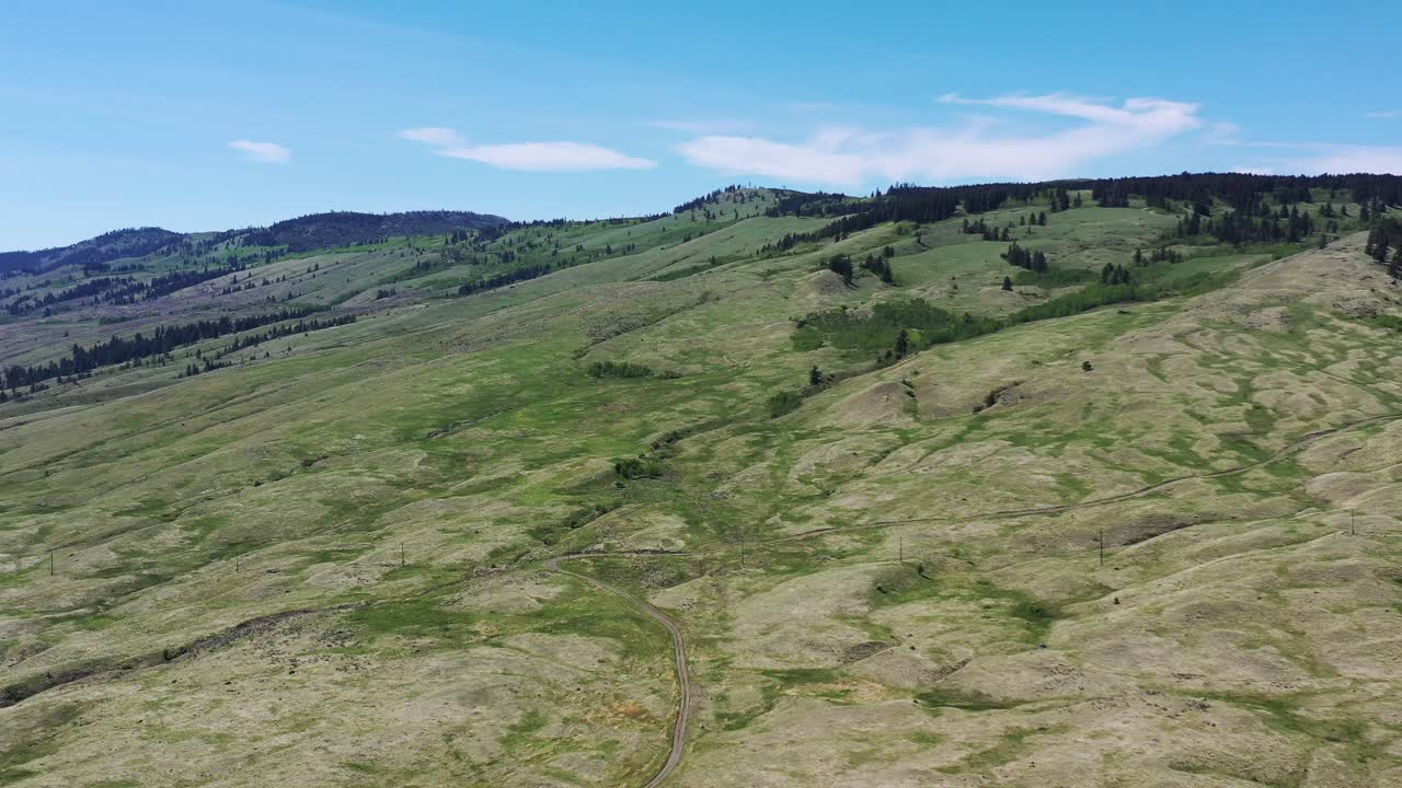 Unveiling Kamloops' Natural Beauty: Majestic Mountains and Vibrant Grasslands Under a Clear Sky