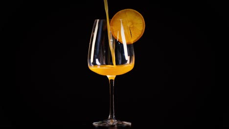 orange juice being poured into a glass