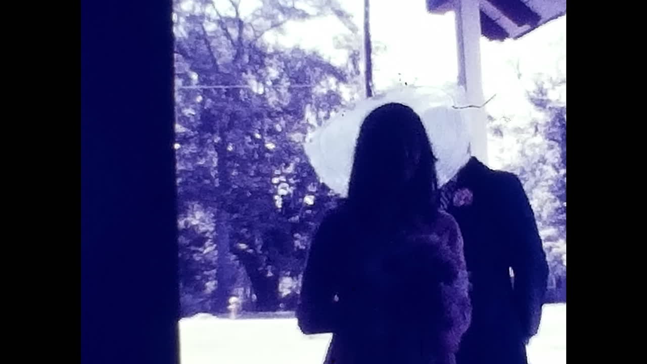 Man and Woman Standing Together in 1970s USA. CIRCA USA - 1970s: A snapshot capturing a man and a woman side by side during the vibrant era of 1970s in the United States.