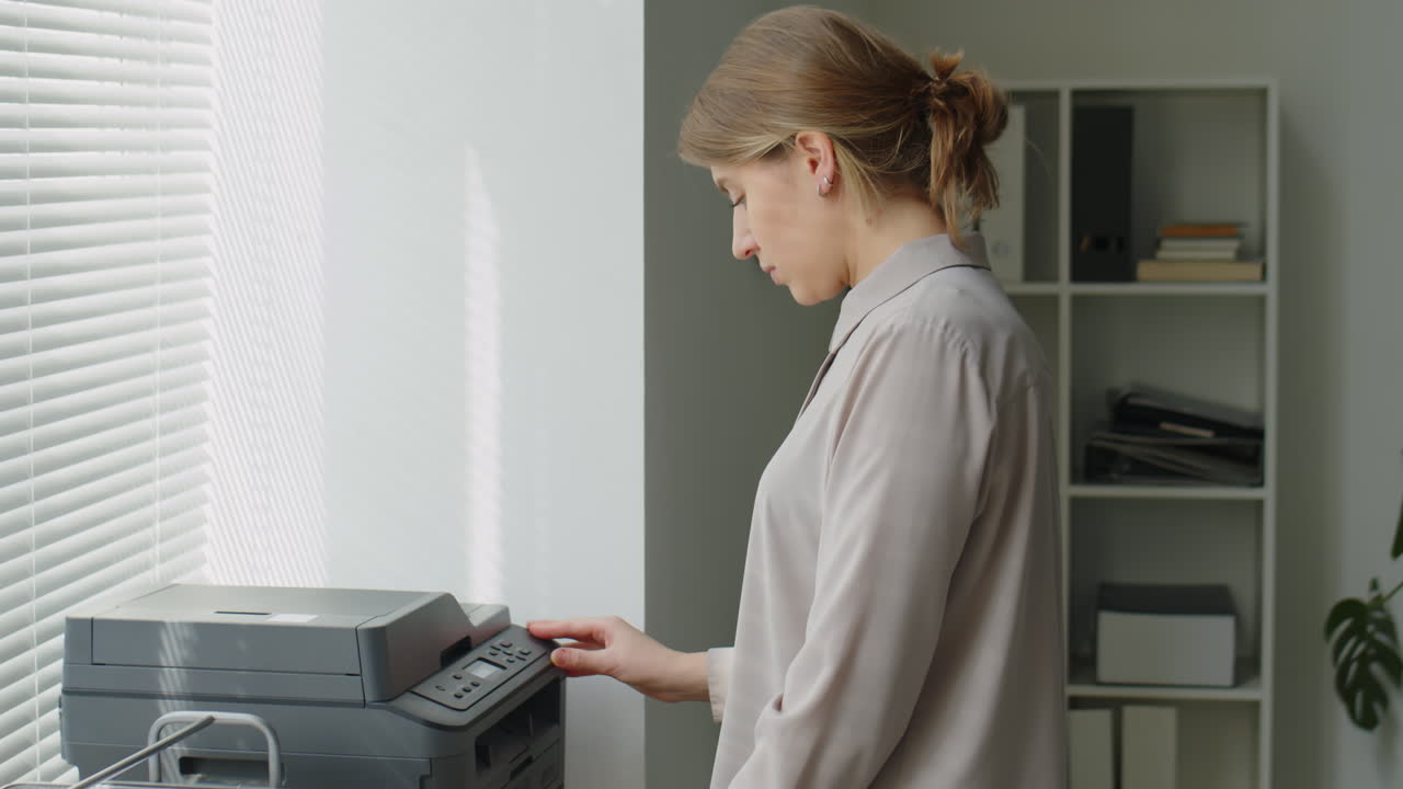 Woman Printing Documents in Office