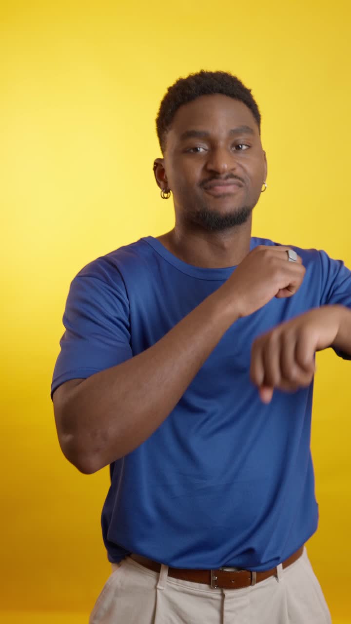 Man in blue shirt on yellow background