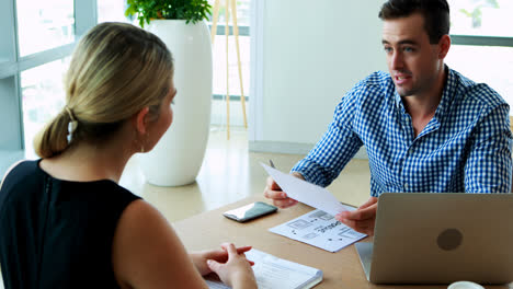 executives interacting with each other at desk