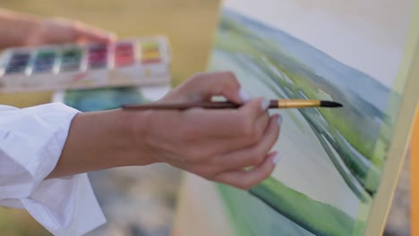 the artist creates a picture with oil paints in the countryside. - the artist creates a picture with oil paints in the countryside. work outdoors