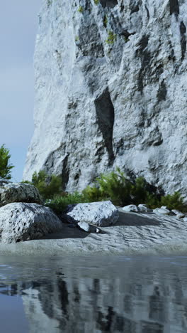 a rocky cliff overlooking a beach and the ocean