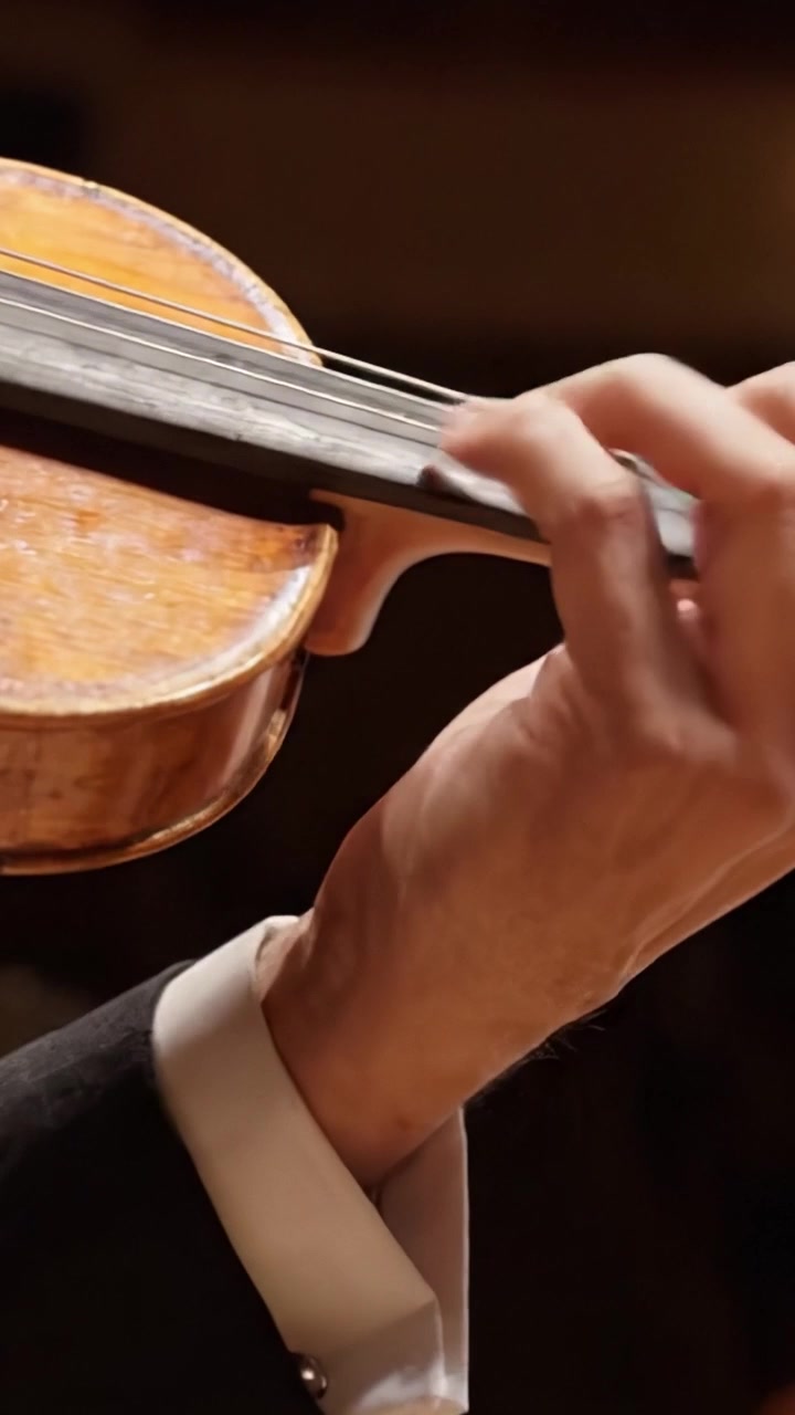 A Close-Up of a Skillful Violinist's Hand Creating Melodic Harmony with an Exquisite Violin, Capturing the Essence of Musical Passion and Precision in a Stunning Performance
