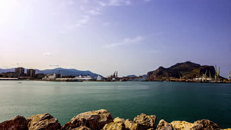 Timelapse-footage-of-a-rocky-shore-with-moving-boats-and-ships-in-the-view-Italy-Sicily