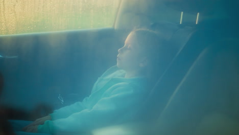 child passenger sits car on stormy day upset little girl expresses boredom of road trip under rain