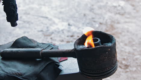 flaming torch for repairing tires in a vulcanizing shop in the philippines - closeup shot