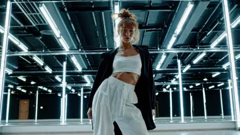 low-angle shot of a dancer in a modern studio with neon lights, capturing a dynamic and edgy video