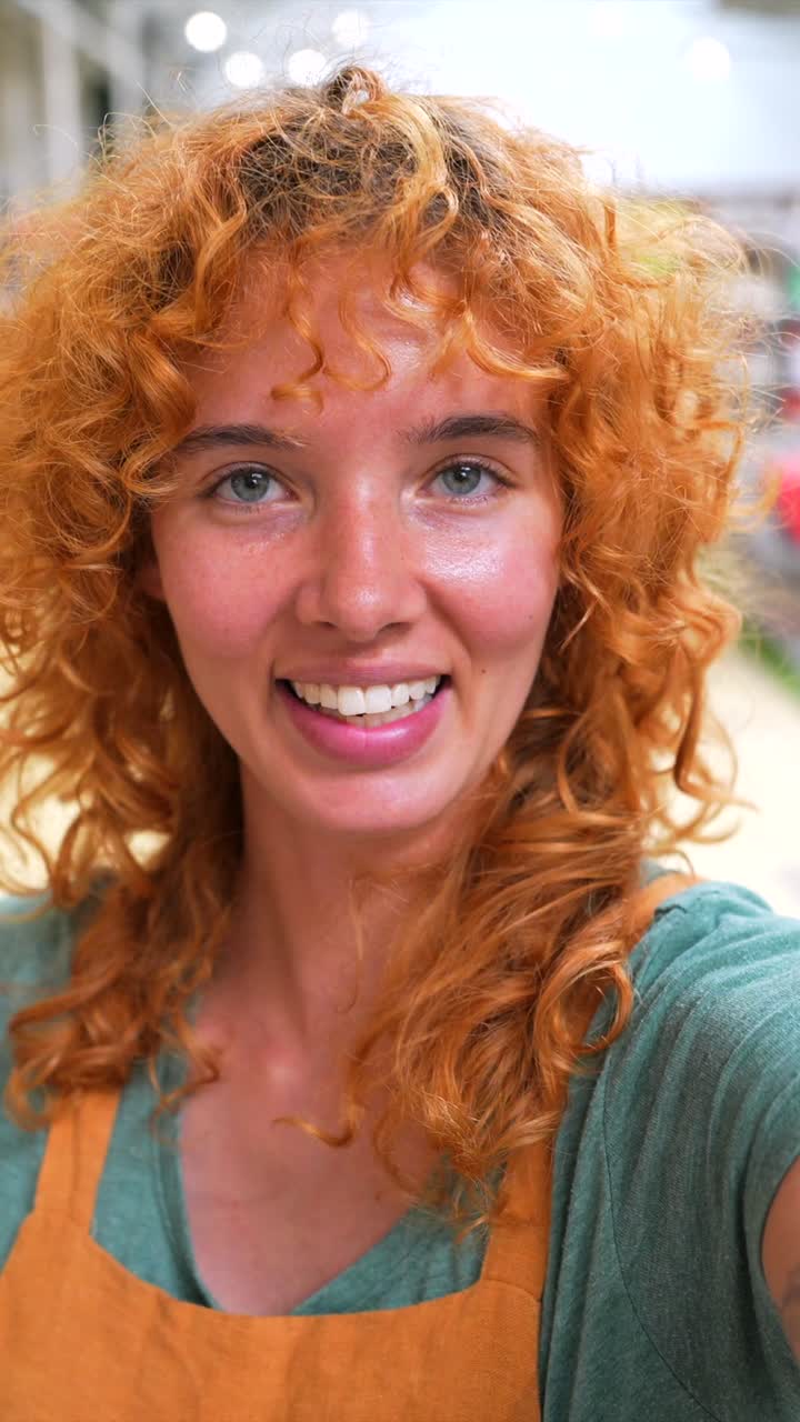 Portrait of a woman with red curly hair