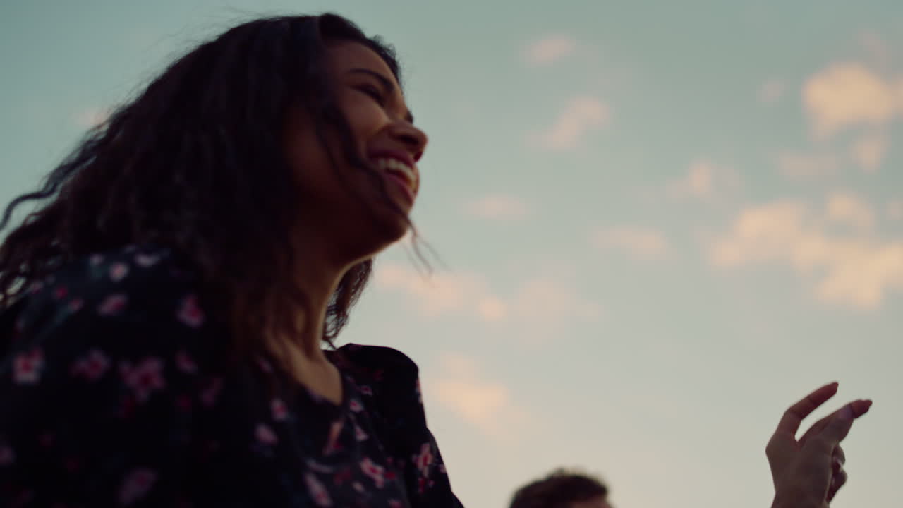 African woman dancing at disco outdoors. Young afro dancer having fun at party