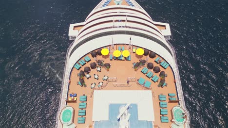 An-aerial-drone-flies-overhead-of-a-cruise-ship-anchored-in-the-bay-of-Cabo-San-Lucas,-Mexico