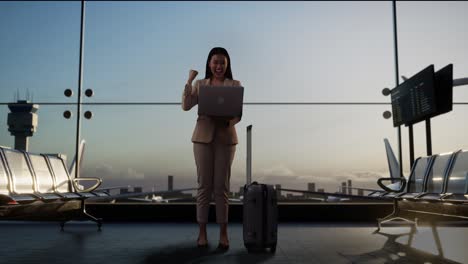 businesswoman celebrating success at the airport