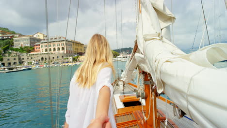 Happy-woman-leading-her-friend-holding-her-hand-to