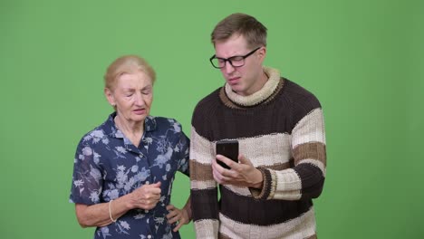 grandmother and grandson using phone then getting bad news together