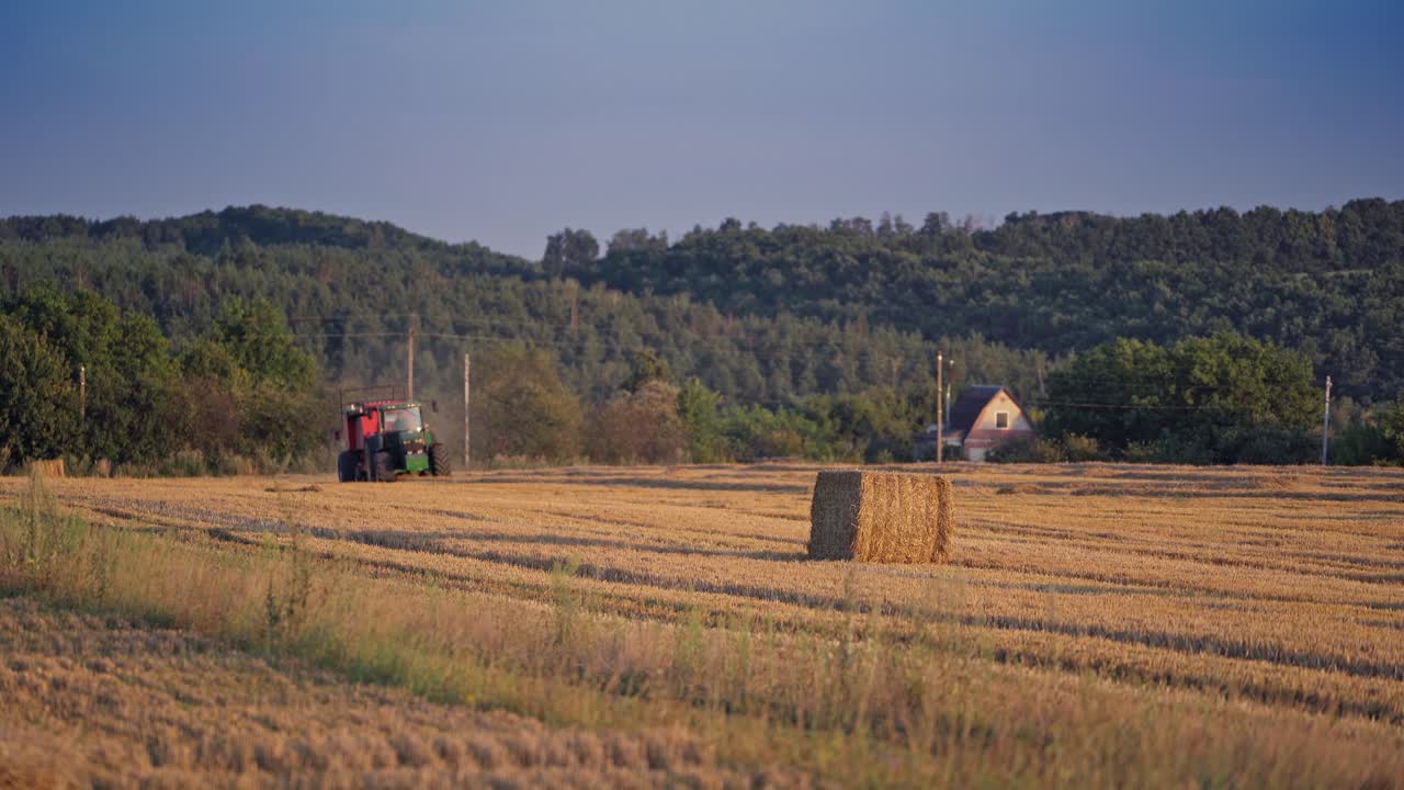 Tractor carrying hay. Agricultural farming haymaking tractor in field