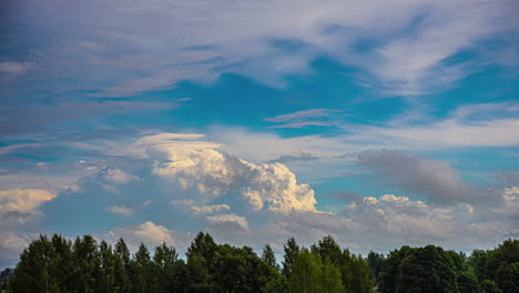 Cloudscape-In-Blue-Sky-Rolling-Over-Trees-On-Sunny-Day