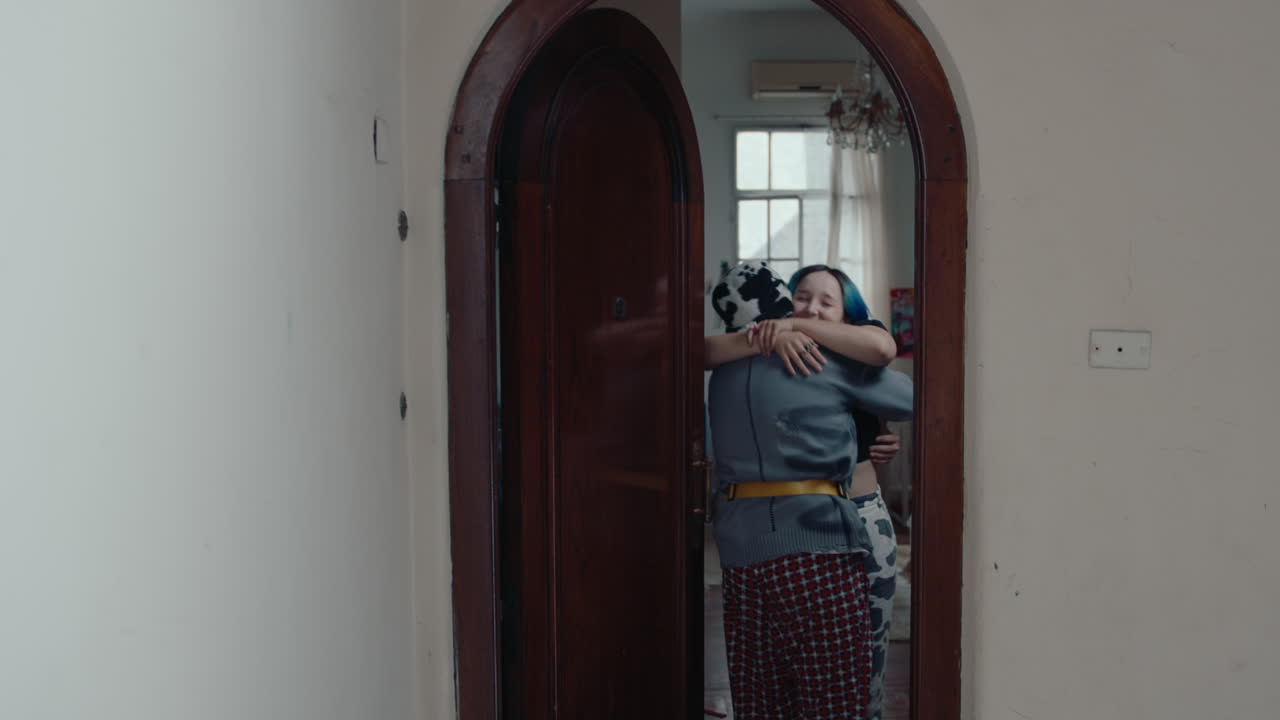 Young Man with Guitar Coming Home and Hugging Girlfriend