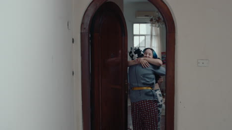 young man with guitar coming home and hugging girlfriend