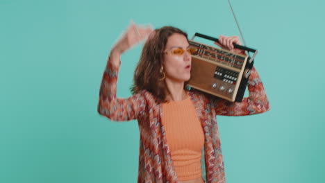 woman using retro tape record player to listen music disco dancing of favorite track having fun