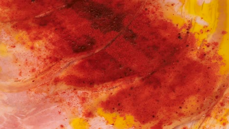 Red-pepper-powder-on-ham-and-olive-oil-combination,-macro-shot