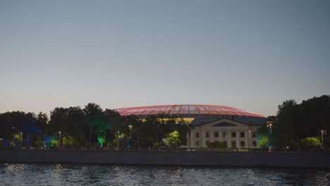 night view of a stadium with a dome and projection lights