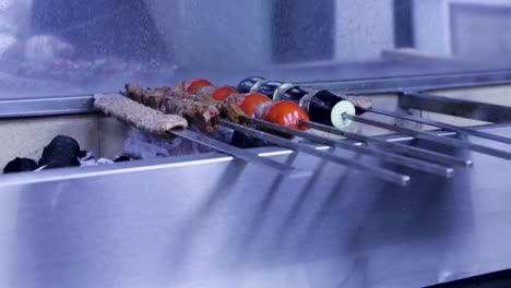 Closeup-chef-align-shish-kebab-on-metal-skewers