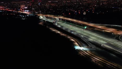 top down night city roads with cars driving aerial view. nightly urban cityscape with modern skyscrapers. majestic cityscape lit by neon lanterns lights with traffic highway. cinematic vehicle scenery