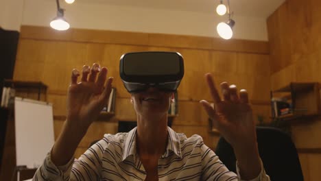 business woman gesturing while using virtual reality headset at office 4k