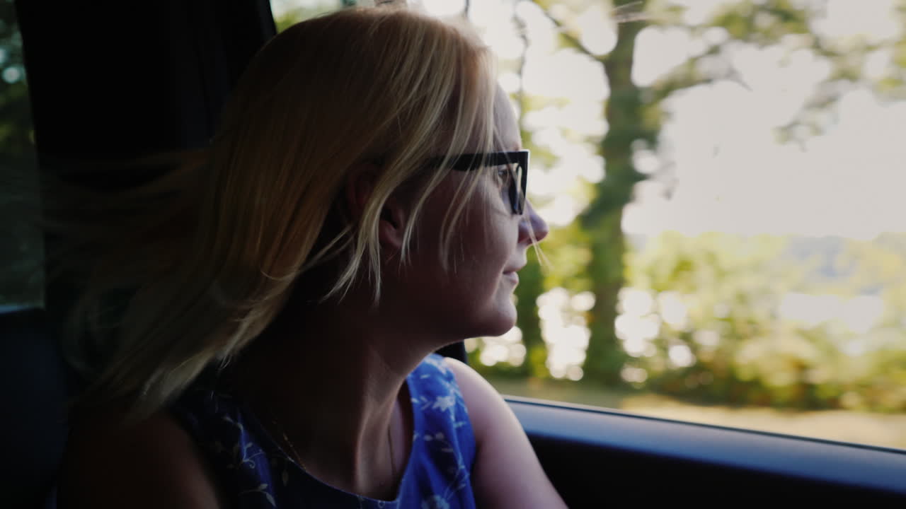 Happy Woman Looking Out of Car Window
