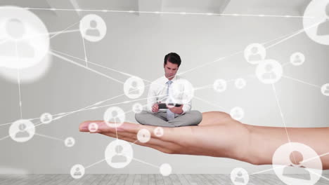 animation of network of connections with icons over caucasian man with tablet sitting on woman hand