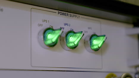 detailed view of a technical equipment interface showcasing glowing green toggle