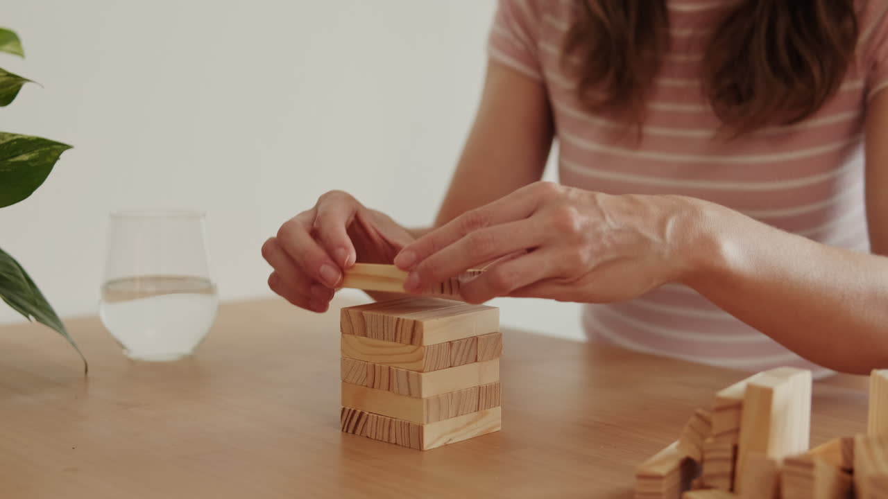 Woman Builds Tower At Home With Blocks
