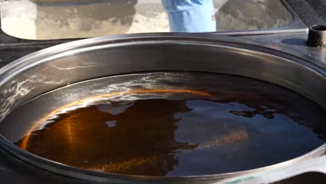 close-up of a large pot filled with hot oil, ready for deep frying