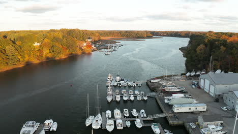 flying over boatyard with several boats on royal river at sunset