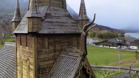 Detail-Of-Wood-Sculptures-On-Roof-Of-The-Wooden-Lom-Stave-Church,-Gudbrandsdal,-Norway,-Scandinavia---aerial-drone-shot