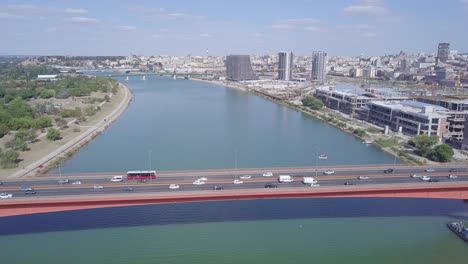 4k aerial orbiting shot of gazela bridge and waterfront in city centre in belgrade