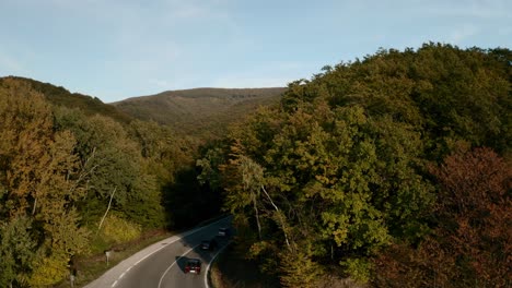 aerial ascending drone reveal footage of a mountain road in autumn