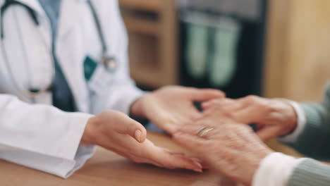 doctor, senior person and holding hands in closeup