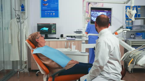 doctor discussing a plan for denture recovery looking at x ray