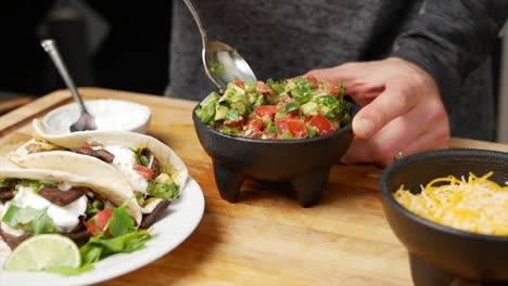 mixing salsa in an authentic style mexican bowl in slow motion style