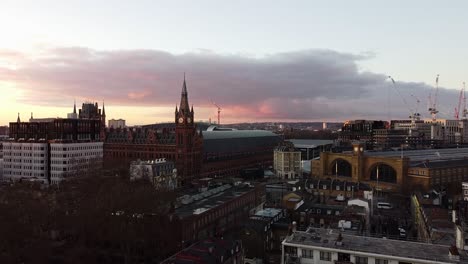 sunset over king´s cross st. pancras station. aerial wide shot.