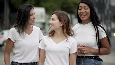 smiling friends waving and talking to camera