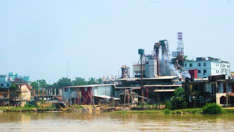 smog from the industrial factory on the riverbanks in bangladesh, south asia