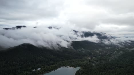 Aerial-drone-view-of-Rattlesnake-Ridge-in-Seattle,-showcasing-the-river,-mountains,-and-lush-green-pines,-creating-a-majestic-nature-scene