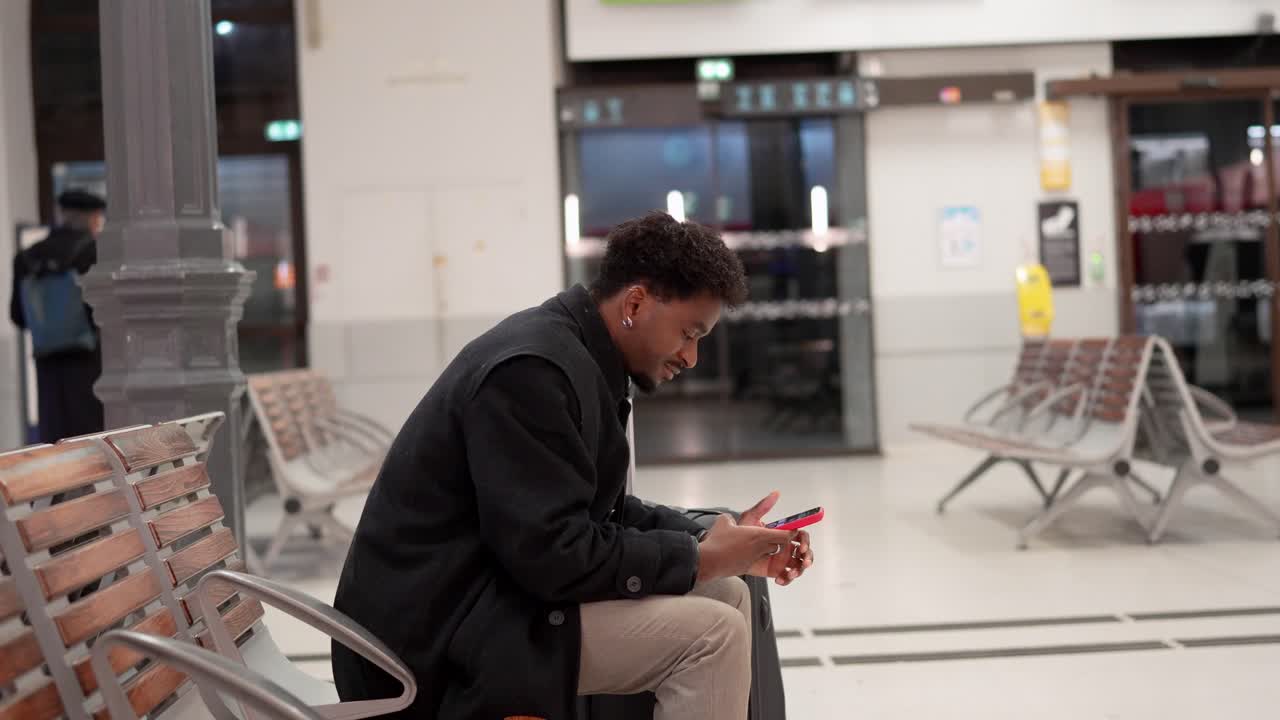 Man with luggage waiting at train station