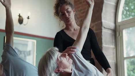 yoga class with senior woman and instructor