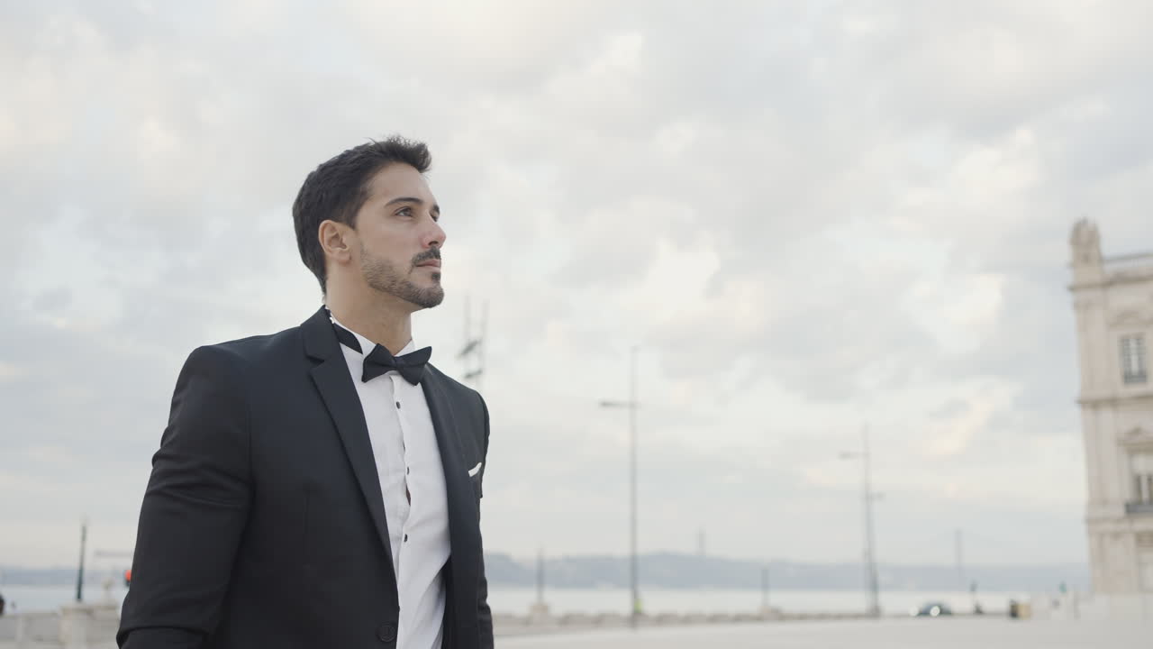 Man in a tuxedo, looking thoughtful