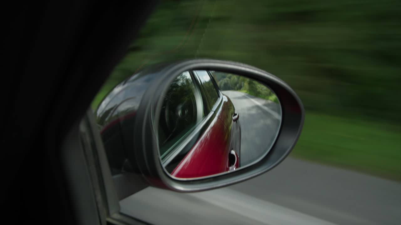 alfa romeo giulia driving looking to back mirror